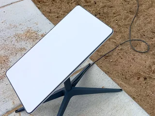 Rectangular Starlink Standard Actuated dish on its mast and X-shaped base